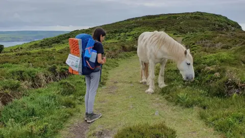 Kerry-Ann Finn on a trail with a wild pony