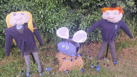 Boy, girl and bee scarecrows at Anlaby Primary School