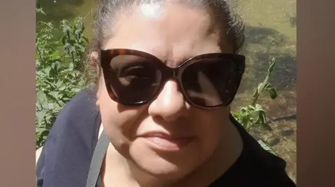 A selfie of Gillian May wearing big dark glasses