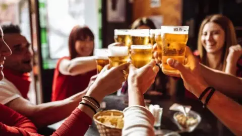 People holding pints