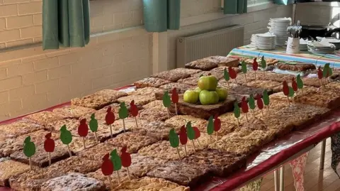 Heather V Hogg  Table with dozens of square Dorset apple cakes