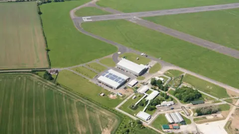 Getty Images A bird's eye view of Chalgrove Airfield in Oxfordshire, with buildings and a runway running to the left of the picture to the top-right corner