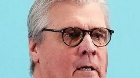 Malcolm Offord, a man with glasses and white hair