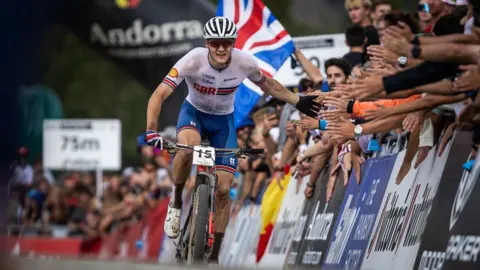 Charlie Aldridge "high fives" the crowd while competing for GB