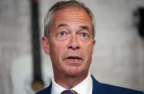 Getty Images Reform UK leader Nigel Farage speaks to the media at The Dam Bar And Grill on May 08, 2026 in St Helens, England. Voters went to the polls yesterday in the local elections across England. Results counted overnight show widespread losses for the Labour Party. Several key Labour councils have surrendered their majority as Reform UK and the Liberal Democrats make significant gains.