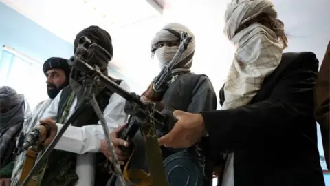 EPA Former Taliban members surrender their weapons during a reconciliation ceremony in Herat, Afghanistan, 21 February 2018.