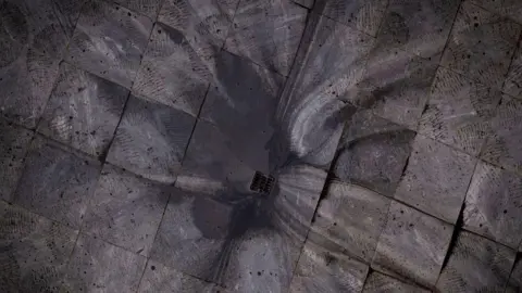 Getty Images Black rainwater flows down a drain in Tehran. 