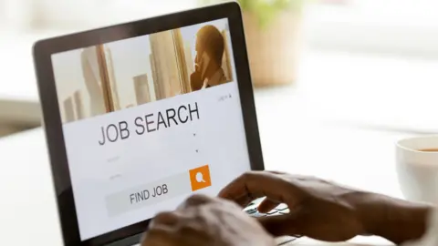 fizkes/Getty Images Person searching for a job