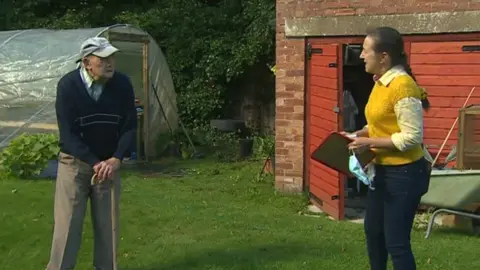 Bill Gosson and his daughter Sandra standing two metres apart in the garden