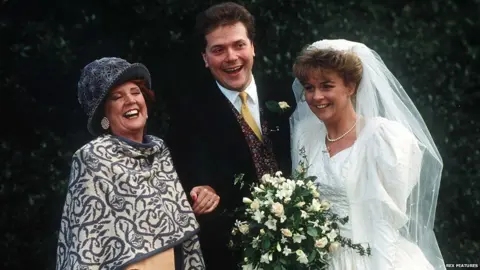 Rex Features Cilla Black with Alex and Sue Tatham on their wedding day