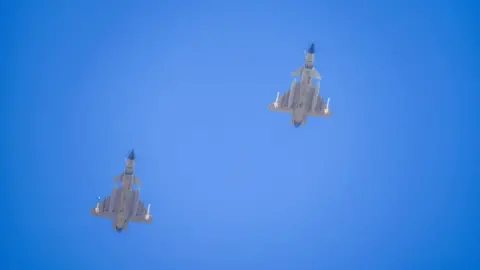 Getty Images Two J-16 air fighters fly over a training base of PLA's naval aviation force in Ningbo in east China's Zhejiang province