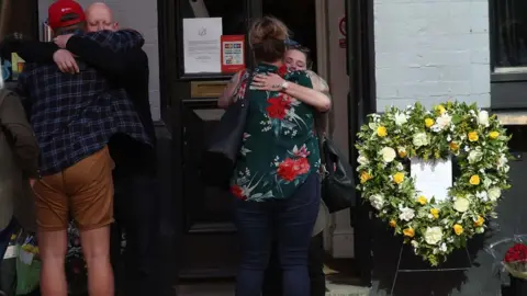 PA Wire Flowers and tributes were laid outside the Blagrave Arms, which is near Forbury Gardens