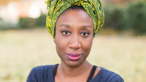 Emma Hook Nephertiti Schandorf in a patterned headscarf