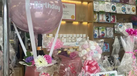 BBC News Gift hampers in a shop, with a happy birthday balloon