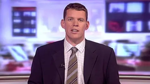 Rhun ap Iorwerth presenting the news on 2009.