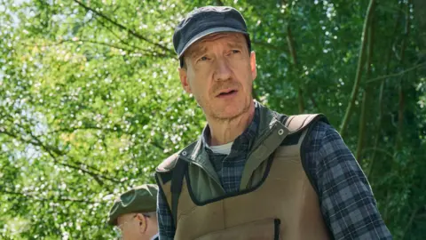 Rob Baker Ashton/Channel 4 Still from Dirty Business with David Thewlis playing Ash Smith.