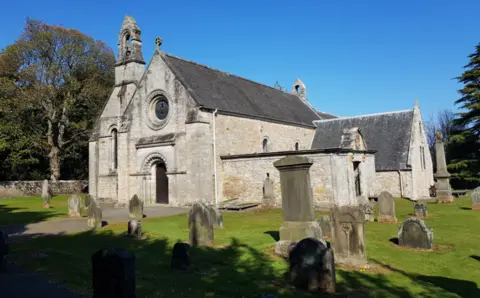 Christina Cowart-Smith A church building with a graveyard outside and bright blue sky above