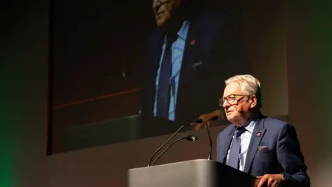 Dafydd Elis-Thomas speaks at a podium 