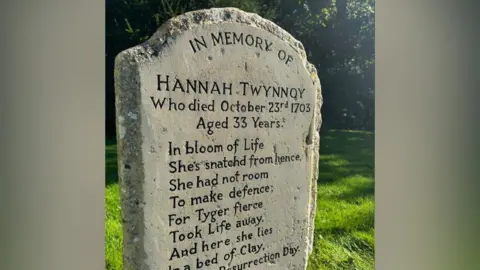 Ben Prater A close-up of the headstone detailing Hannah Twynnoy's date of death and showing a poem which includes the words, "For Tyger fierce Took Life away".