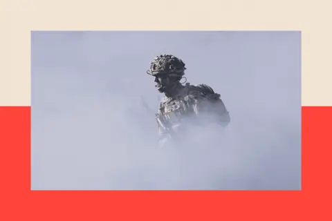 Getty Images Europe A soldier of the United Kingdom's 2nd Battalion Royal Anglian infantry unit runs through smoke as he storms an enemy position in a simulated attack