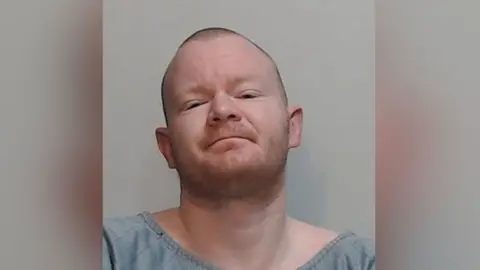 Police Scotland A police picture of a man with short red hair and a slight growth of red beard