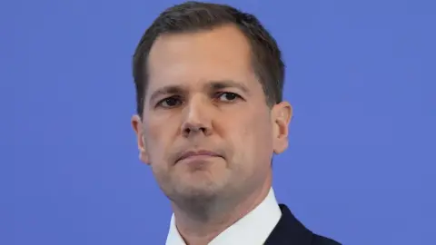 PA Media Tory leadership hopeful Robert Jenrick, wearing a suit, looks into the middle distance