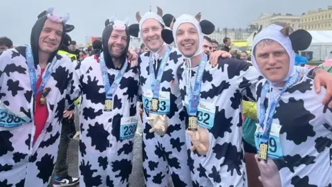 Five men dressed as cows during the Brighton half-marathon 2026