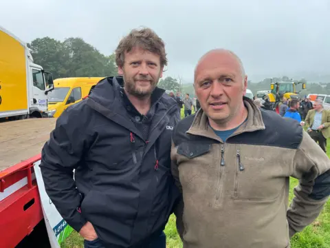 Gary Howells (left), with Aled Rees, on farmland