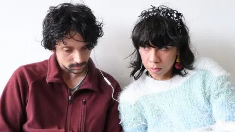 Applied Stories Two people listening to stories at an event