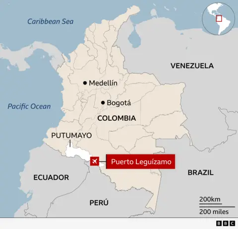 Map of Colombia highlighting the town of Puerto Leguízamo in the department of Putumayo near the borders with Ecuador, Peru and Brazil. Major cities Medellín and Bogotá are marked. The map shows surrounding countries and bodies of water, with an inset map indicating the region’s location in South America