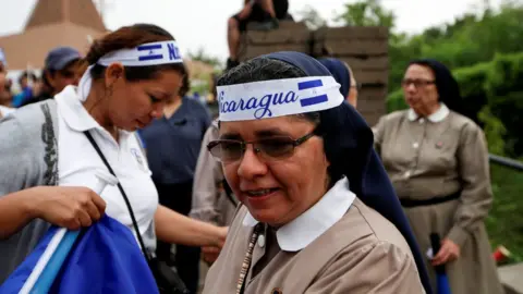 Reuters Nuns are seen wearing headbands in the country's national colours