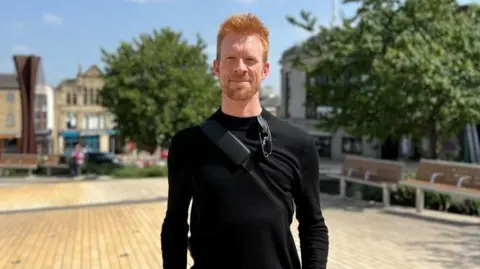 Ed Clancy dressed in a black jumper