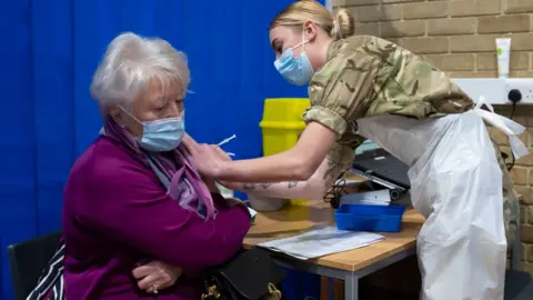 Getty Images Woman being vaccinated