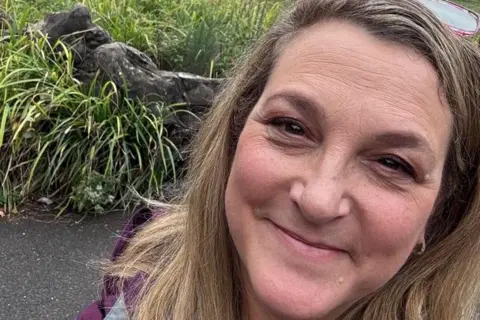 Supplied A selfie of a women with blonde/brown hair in front of some bushes.