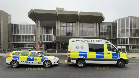 Getty Images Police vehicles at Hove Town Hall