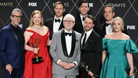 Getty Images Alan Ruck, Sarah Snook, Alexander Skarsgård, Brian Cox, Nicholas Braun, Kieran Culkin, Matthew Macfadyen, and J. Smith-Cameron, winners of Best Drama Series for "Succession," pose in the press room at the 75th Primetime Emmy Awards held at the Peacock Theater on January 15, 2024 in Los Angeles, California