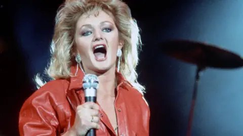Getty Images Singing Bonnie Tyler wearing a red leather jumpsuit