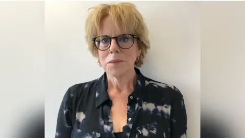 Shelter Polly Neate, a white woman with blond hair in a black shirt