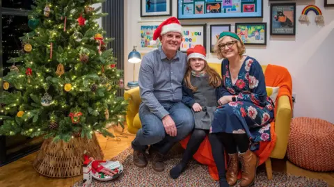 Kiirsty Anderson The family sitting on a sofa