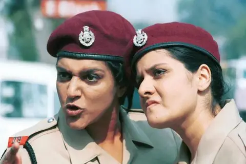 A still of the TV show Goodness Gracious Me!, with actresses Meera Syal and Nina Wadia playing Delhi policewomen.