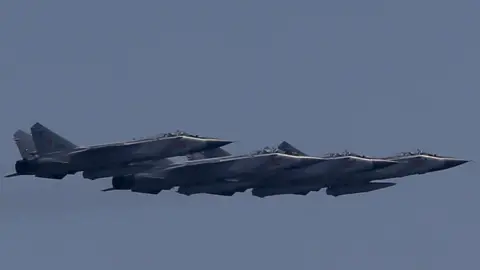 Sefa Karacan/Anadolu Agency via Getty Images Four MIG-31 jets flying in formation