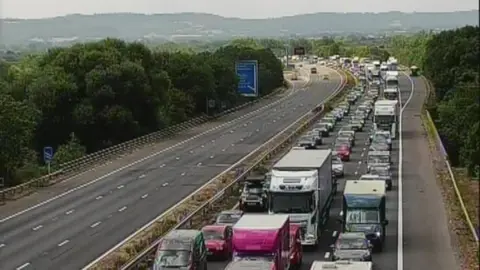 A traffic jam on the M5 in Somerset. One side of the motorway is clear, while the other is congested.