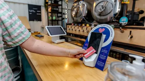 Bristol City Centre BID A man clicking a contactless donation point