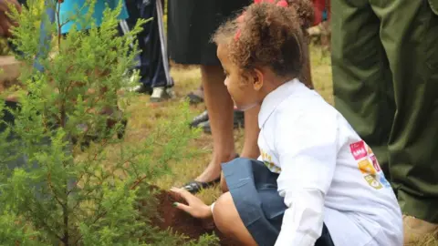 Ellyanne Wanjiku Chlystun An archive picture of a young Ellyanne Wanjiku Chlystun planting a tree.