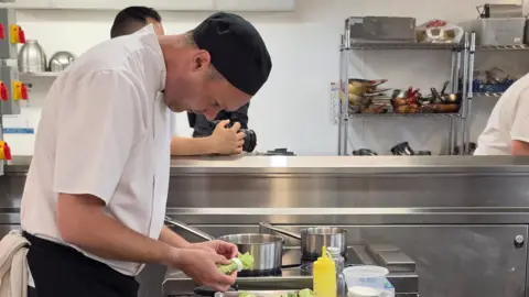 Richard preparing food in a kitchen. 