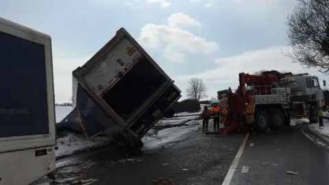 Snow in Dorset Lorry overturns and schools closed