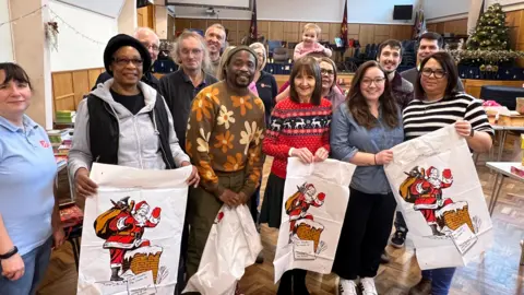 Volunteers of the Salvation Army standing looking at the camera