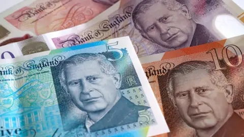 Photo showing a £5 note, a £10 note and a £20 note.