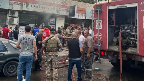 Getty Images  first responders gather at the scene of a reported device explosion in Saida in southern Lebanon 