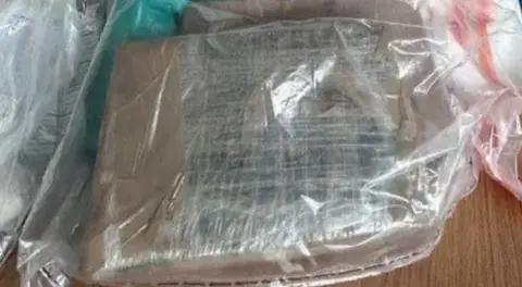 Shows a block of cannabis in a see-through plastic bag 